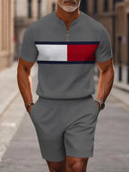 Men's two-piece set featuring a short-sleeved, half-zip polo top with a small stand-up collar and printed pattern, paired with shorts.